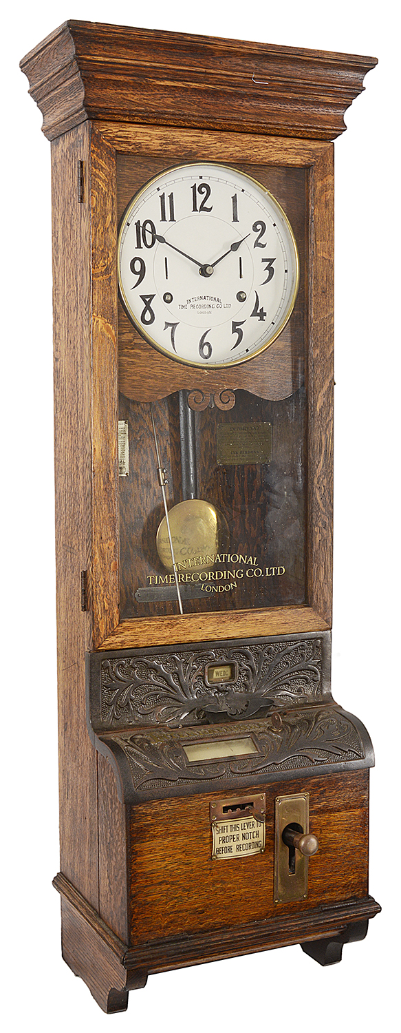 An oak cased International Time Recording Ltd clocking in/clocking out clock