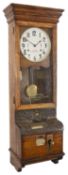An oak cased International Time Recording Ltd clocking in/clocking out clock