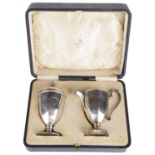 A George V cased silver sifter and cream jug, hallmarked Birmingham 1925