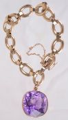 A gold link bracelet with large amethyst pendant drop, approx. 30 carats