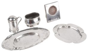 A collection of George V and later silver, trinket trays, mustard, frame and pepperette