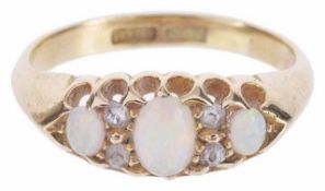 A delicate three stone precious opal and diamond set ring