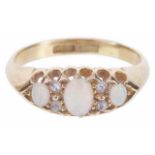 A delicate three stone precious opal and diamond set ring