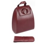 A Cartier burgundy leather backpack, with leather comb holder (2)