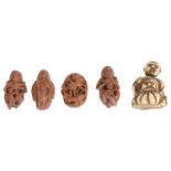 A small late 19th century Japanese carved netsuke and four coquilla nut carvings