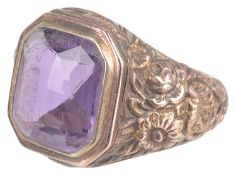 A large repousse decorated amethyst set ring