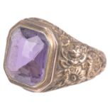 A large repousse decorated amethyst set ring