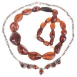 A silver mounted amber set necklace and an amber bead necklace