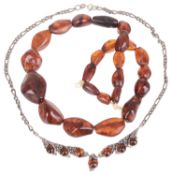 A silver mounted amber set necklace and an amber bead necklace