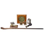 A collection of Victorian and later desk items and a character face carved swagger stick