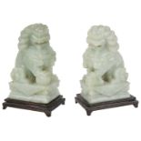 A pair of Chinese green hardstone carved Buddhistic lions, mid 20th century