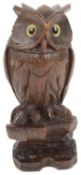 An early 20th century Black Forrest novelty inkwell and pen rest in the form of an owl