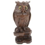An early 20th century Black Forrest novelty inkwell and pen rest in the form of an owl