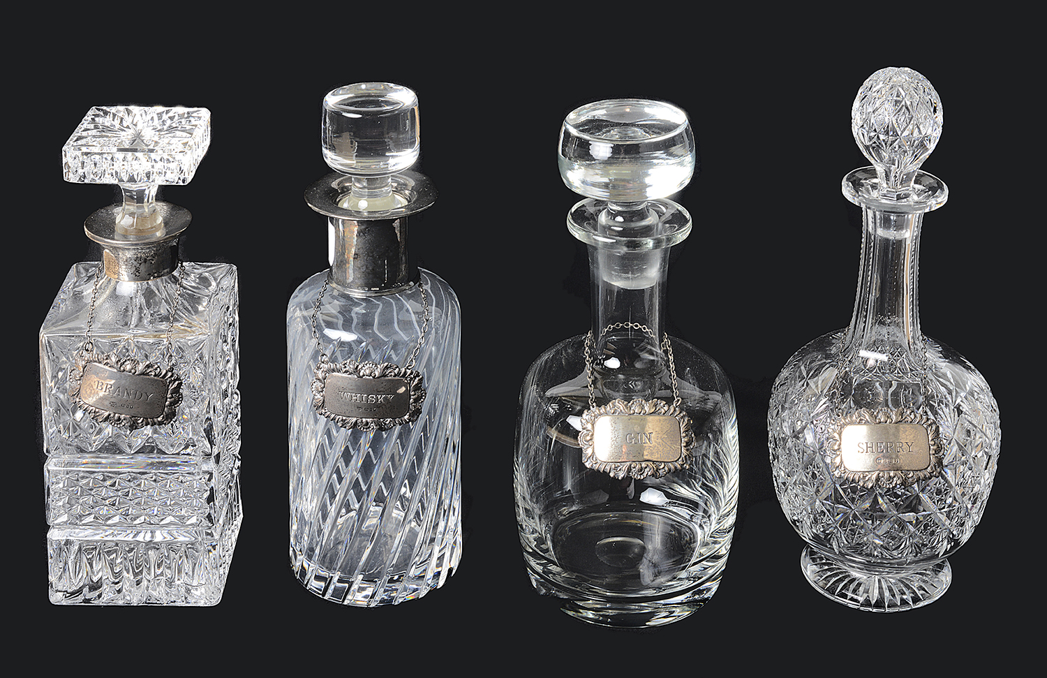 Four glass decanters with silver decanter labels, 20th century