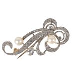 An attractive early 20th century diamond and pearl scroll brooch