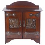 An Arts and Crafts mahogany pipe wall cabinet, early 20th century