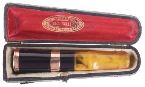 A French 18k gold amber and black Bakelite cheroot holder