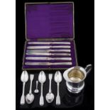 A small collection of silver flatware and a silver jug