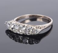 A seven stone diamond set scroll mounted ring