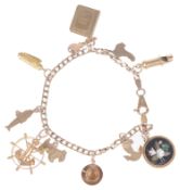 A delicate 9ct gold charm bracelet suspended with various gold charms