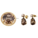 An 18ct gold mounted circular smoky quartz set brooch; drop earrings