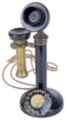 A candlestick telephone