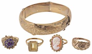 A collection of four gold mounted dress rings