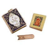 A miniature enamel Quran charm, complete with tiny Quran inside