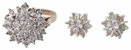 A diamond set cluster ring and matching earrings