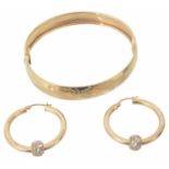 A contemporary 9ct gold hinged bangle; pair of gold hoop earrings