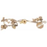 A 9ct gold fancy link charm bracelet with heart padlock fastening