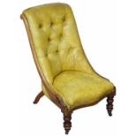 A Victorian mahogany and olive leather nursing chair