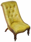 A Victorian mahogany and olive leather nursing chair