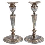 A pair of silver candlesticks, hallmarked London 2002