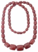 A long red amber graduated large bead necklace