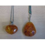 TWO AMBER COSTUME PENDANTS ON 925 SILVER CHAINS