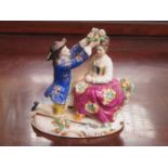 CONTINENTAL STYLE HANDPAINTED AND GILDED FIGURE GROUP OF A LADY AND GENT,