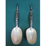 PAIR OF DECORATIVE BUFFALO AND MOTHER OF PEARL SERVING SPOONS,