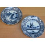 TWO DELFT STYLE CONTINENTAL BLUE AND WHITE CERAMIC PLATES (AT FAULT)
