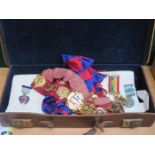 CASE CONTAINING MASONIC REGALIA INCLUDING SILVER GILT MEDALS, GILT METAL SASH, APRON ETC.