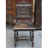 CARVED AND PIERCEWORK DECORATED ANTIQUE OAK HALL CHAIR