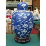 LARGE ORIENTAL BLUE AND WHITE PRUNUS PATTERN GINGER JAR WITH COVER ON TREEN SUPPORT,