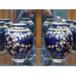 PAIR OF LIMOGES GILDED FRUIT AND VINE DECORATED CERAMIC VASES,