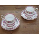 PAIR OF FLORAL DECORATED CERAMIC CUPS AND SAUCERS