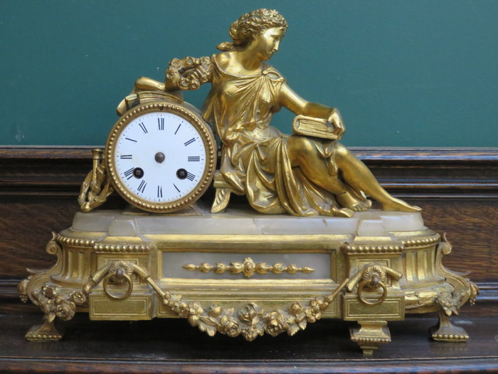 PRETTY GILT METAL FRENCH STYLE MANTEL CLOCK DEPICTING A RECLINING LADY,