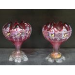 PAIR OF PRETTY CRANBERRY GLASS VASES WITH FLORAL DECORATION ON RAISED SUPPORTS,