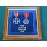 FRAMED FIRST AND SECOND CLASS WORLD WAR II GERMAN IRON CROSSES PLUS ANOTHER GERMAN MEDAL