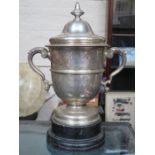 HALLMARKED SILVER TWO HANDLED TROPHY ON EBONISED STAND, LONDON ASSAY,