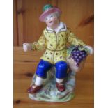 SMALL ROYAL CROWN DERBY FIGURE OF A SEATED GENT WITH FRUIT,