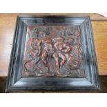 HEAVILY CARVED RELIEF TREEN PLAQUE DEPICTING MYTHICAL CREATURES IN EBONISED FRAME,